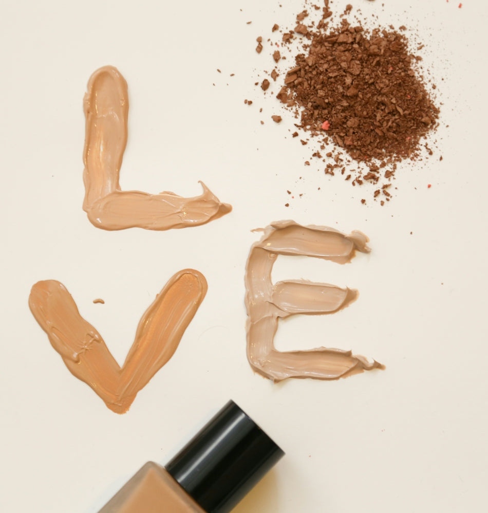 Foundation makeup spells out the word love